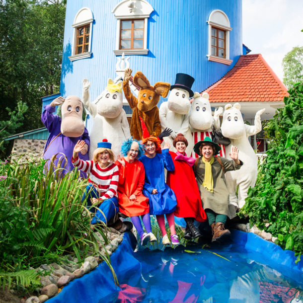 Moomin characters in front of the Moominhouse.